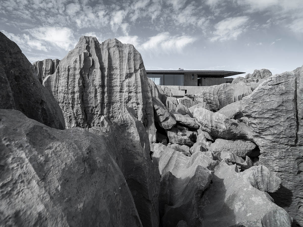 Karim Nader Studio built retreat expanding landscape with dispersed boxes and zinc roof on the rocks