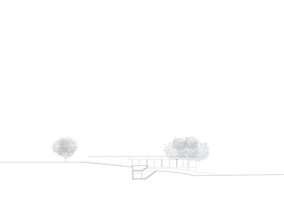 Low-profiled whitewashed stone walls wrap living units of Casa da Volta by PROMONTORIO and João Cravo