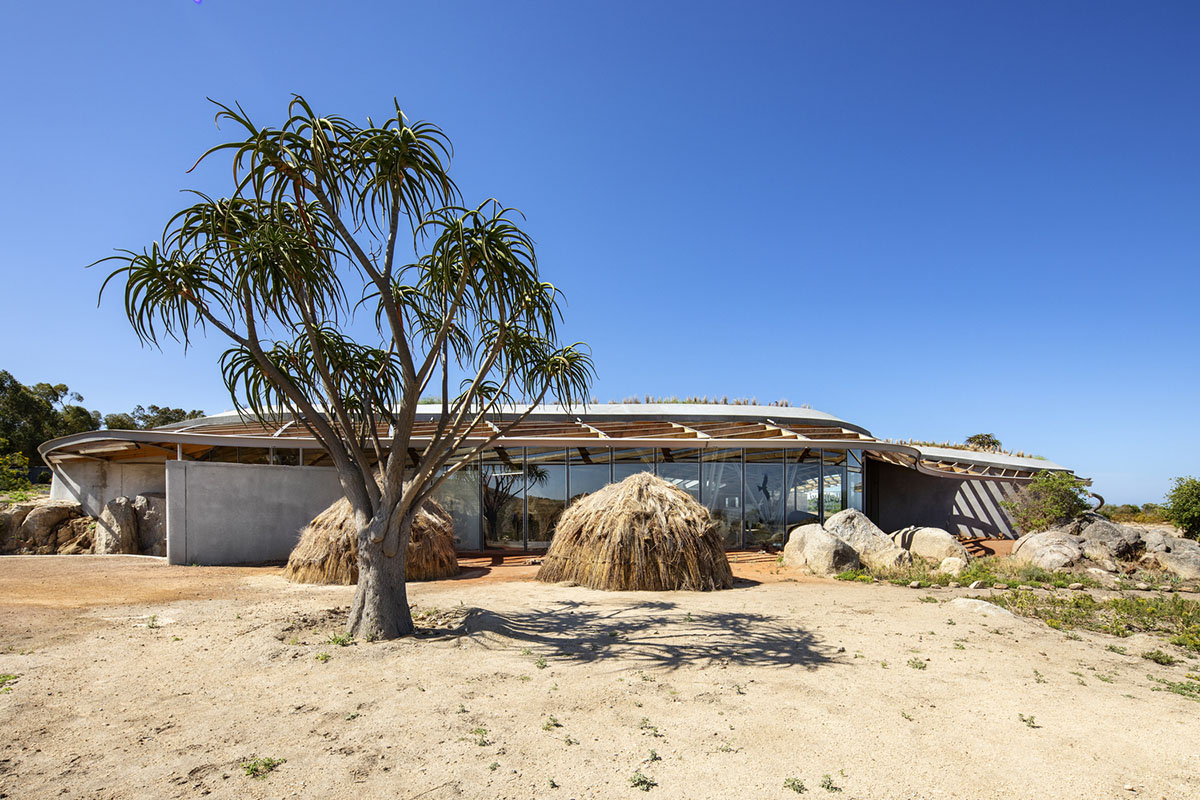 KLG Architects completes heritage center with undulating roof that acts as a small shelter