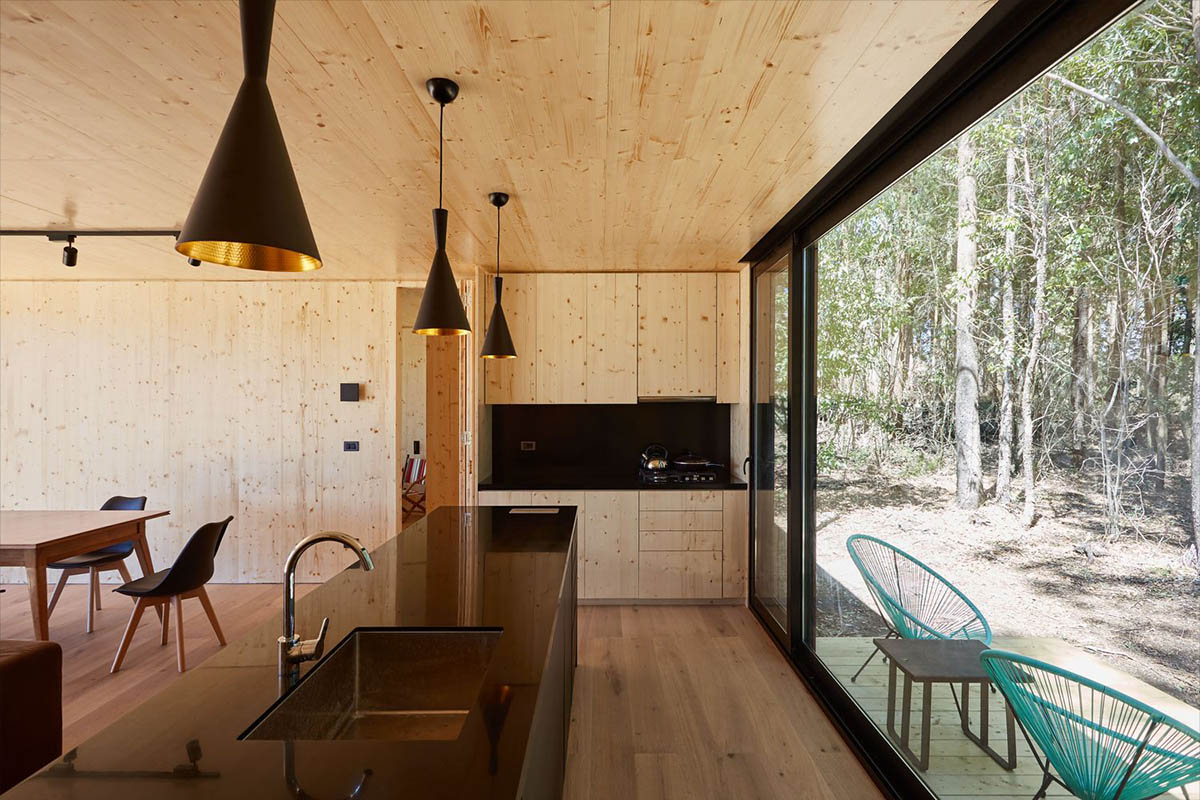 Black wooden cabin by iHouse estudio is an off-grid escape home in Uruguayan native forest