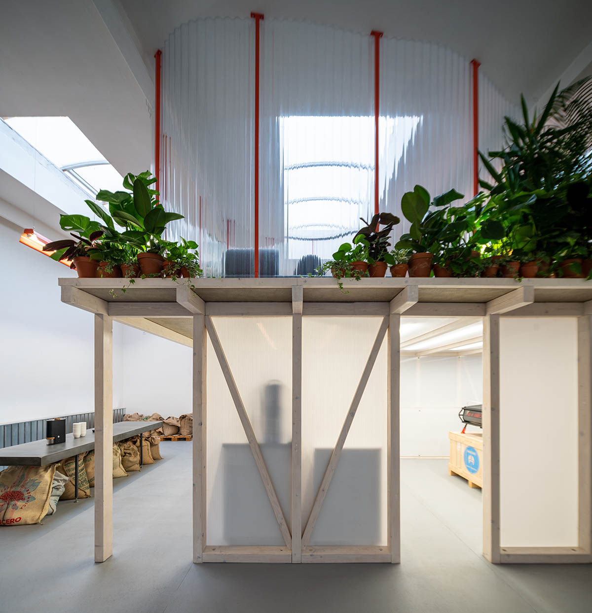 KOGAA crowns Prague's industrial coffee hub with additional working space filled with loop of plants