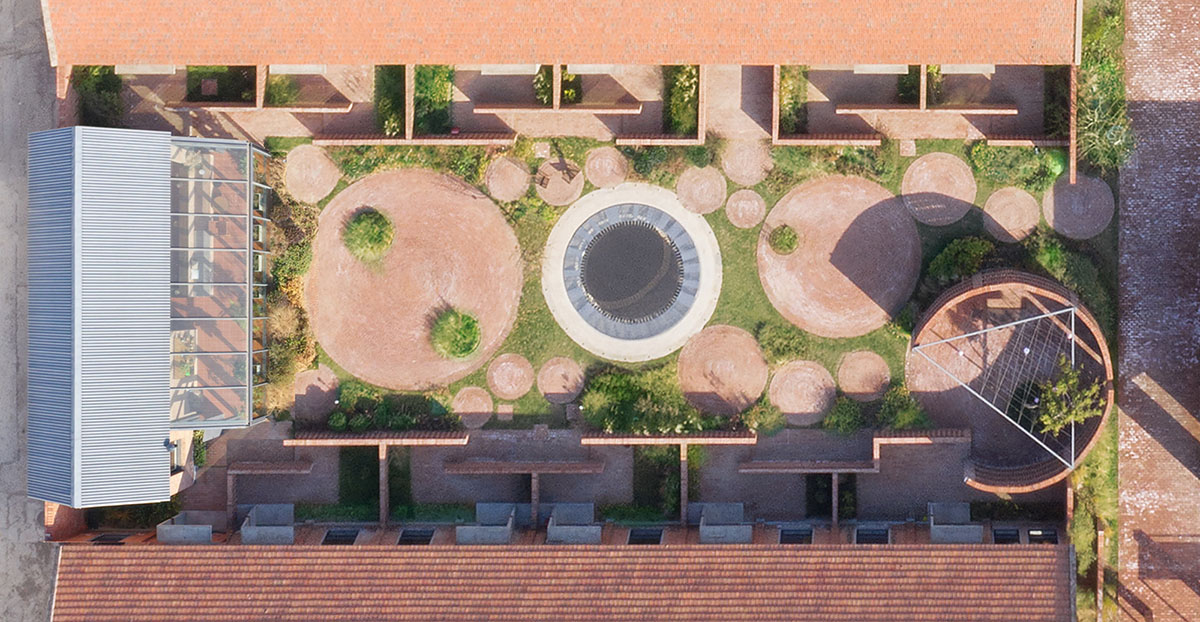 REDe Architects and Moguang Studio add red circular platform to renovated youth activity center