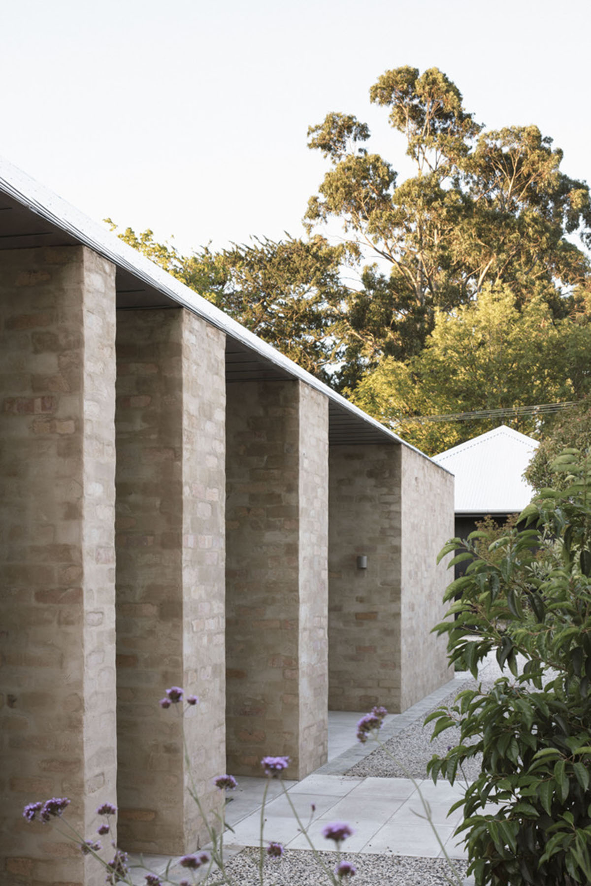 Textured brick walls reflects light, colour and textures of Autumn in Kyneton House by Edition Office