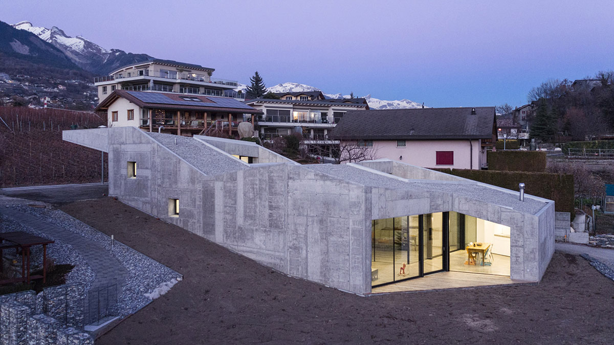 Anako Architecture completes slopped concrete residence in Switzerland