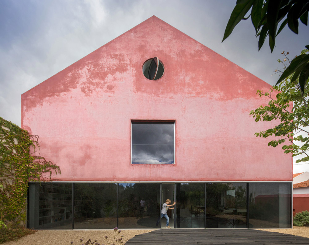 Extrastudio converted former winery in Portugal  into a new family home with red mortar walls