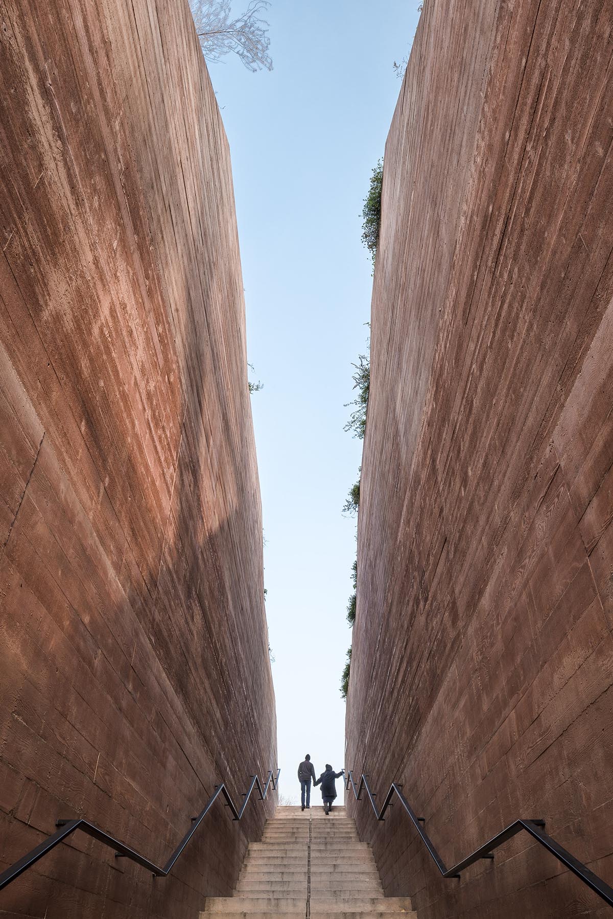 BBGK Architekci designed 12-metre-high stained concrete wall to narrate victims for Katyn Museum