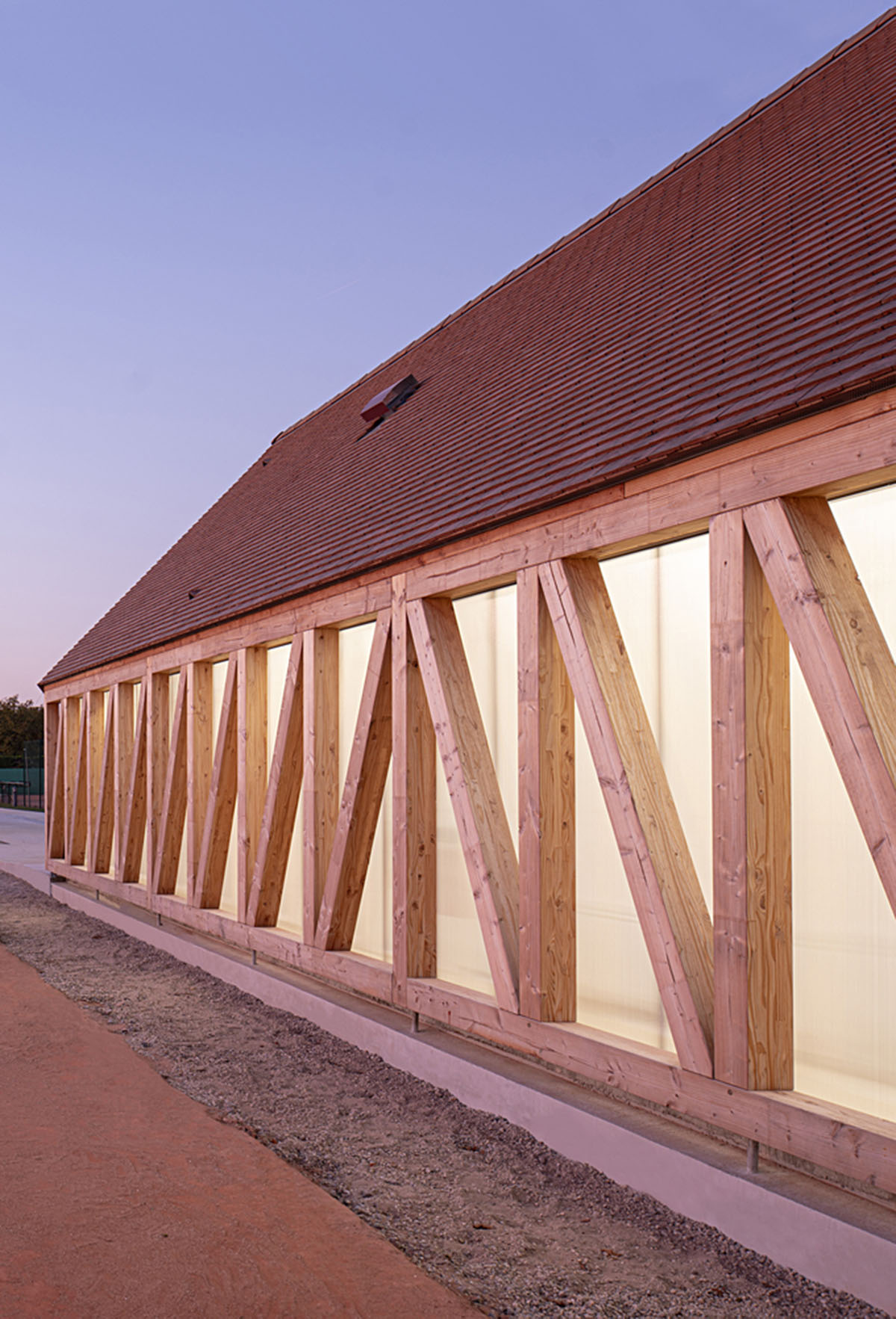 Lemoal Lemoal Architectes wraps tennis club with half-timbered facade elements in Cabourg