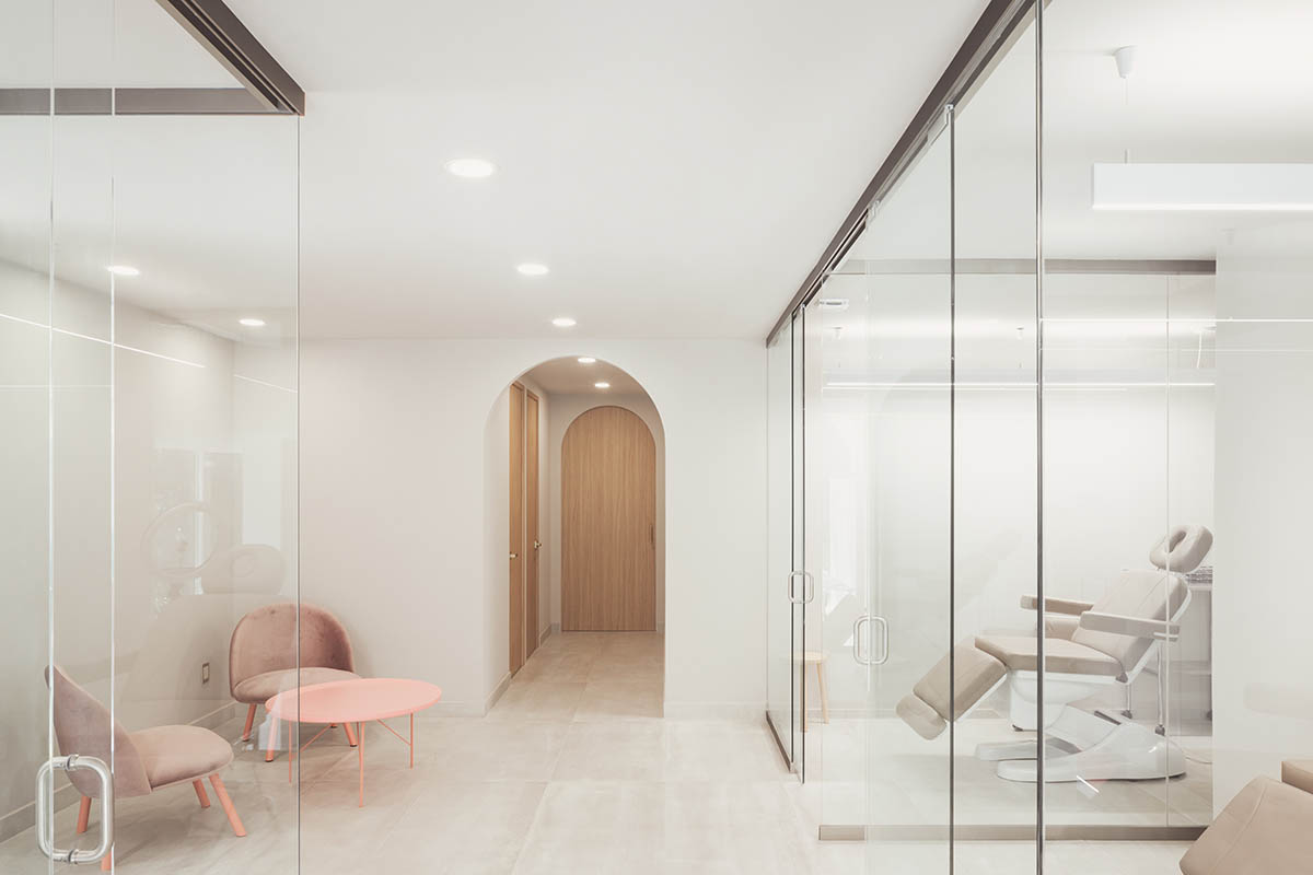 VOID Studio amplifies the mechanism of work with soft pinkish staircase and cabin-like stations
