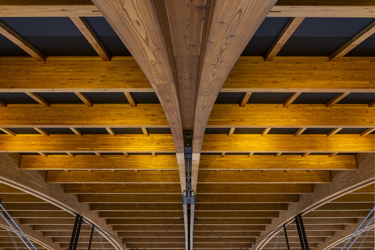 Nikken Sekkei and Shimizu Corporation-designed gymnastics centre features a floating wooden vessel