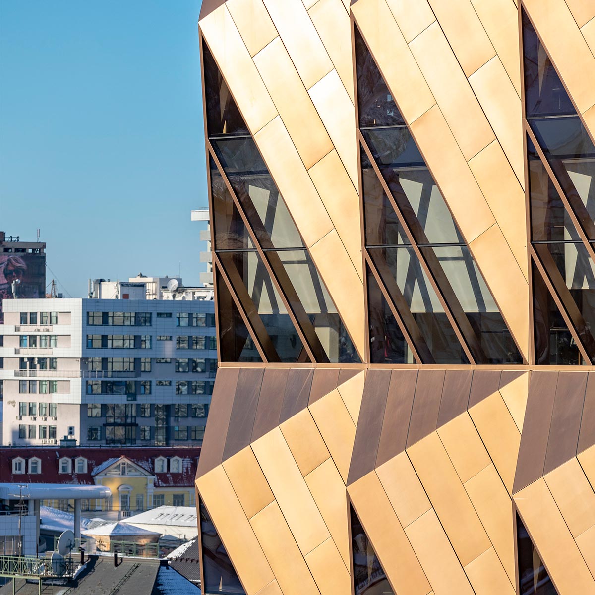 Foster + Partners completes office tower clad by triangular pieces of copper in Yekaterinburg