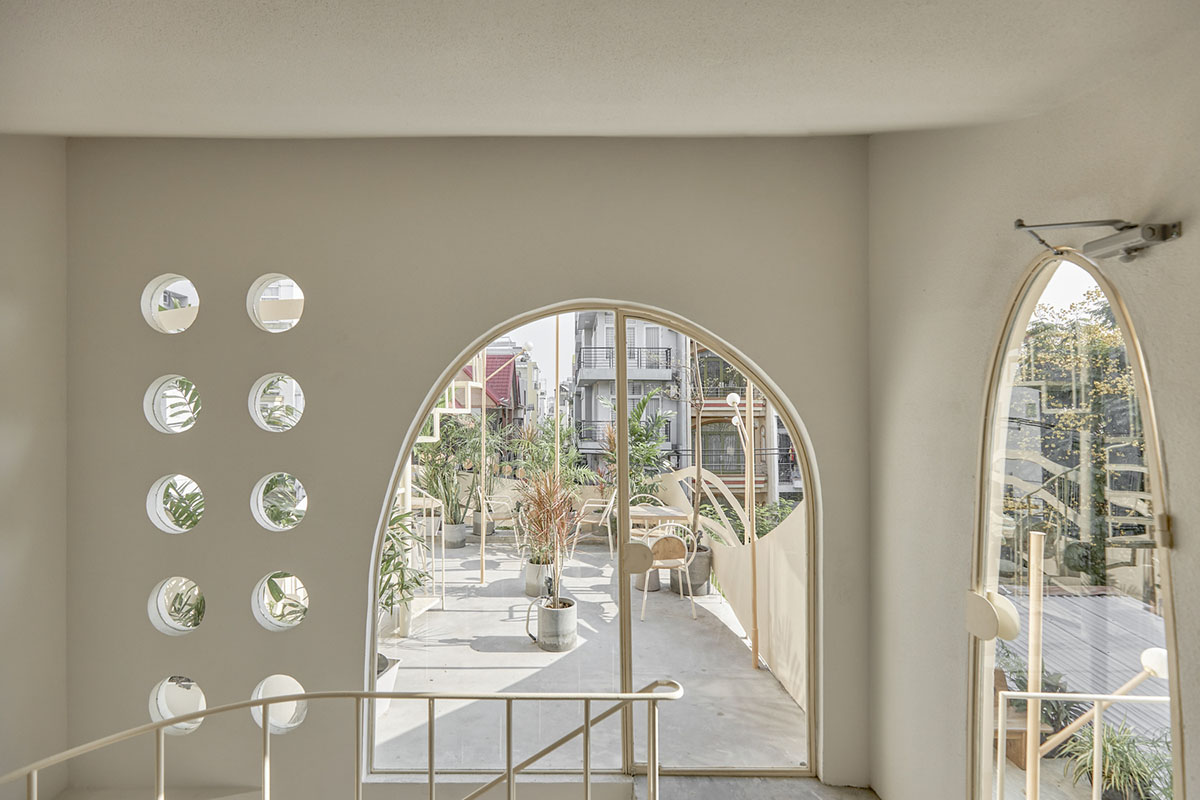 September Cafe is designed to look like a bird's nest with curved steel stripes in Vietnam