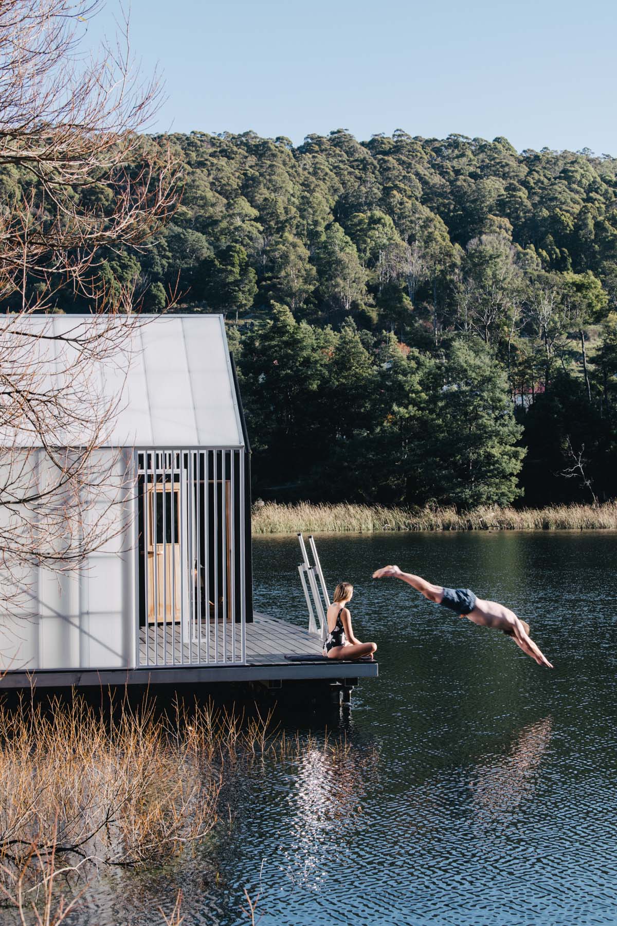 Licht Architecture built a floating sauna with black and white volumes on Tasmanian's Derby Lake