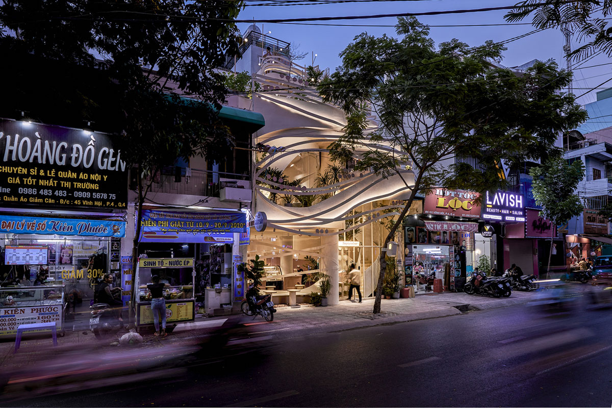 September Cafe is designed to look like a bird's nest with curved steel stripes in Vietnam