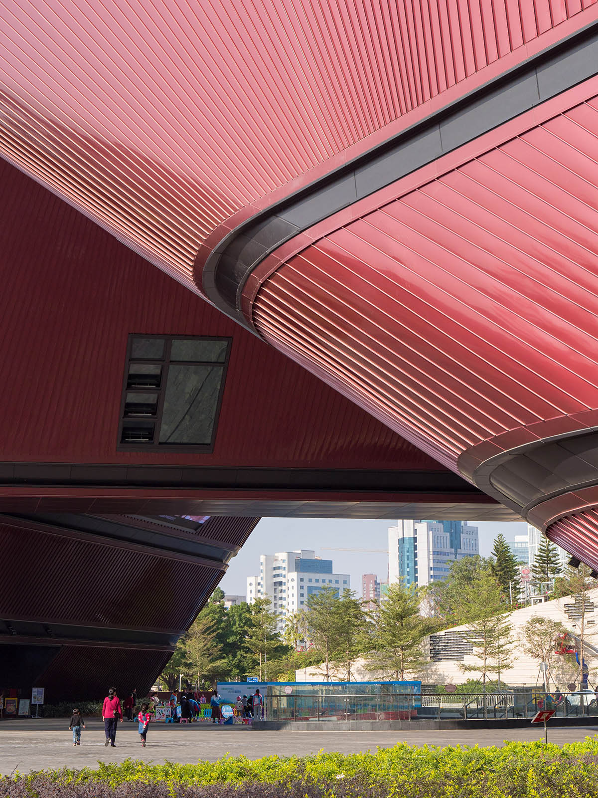 Mecanoo's Cultural Centre in Shenzhen acts as monolithic urban connector with tilted facades