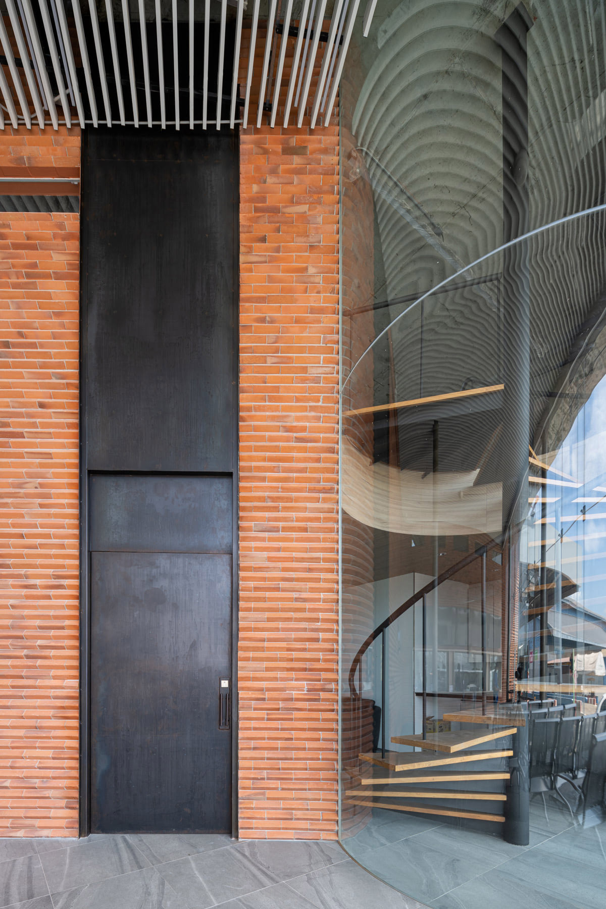 PHTAA living design completes Lorpoonphol Rice Mill Office featuring zig-zag brick wall in Thailand