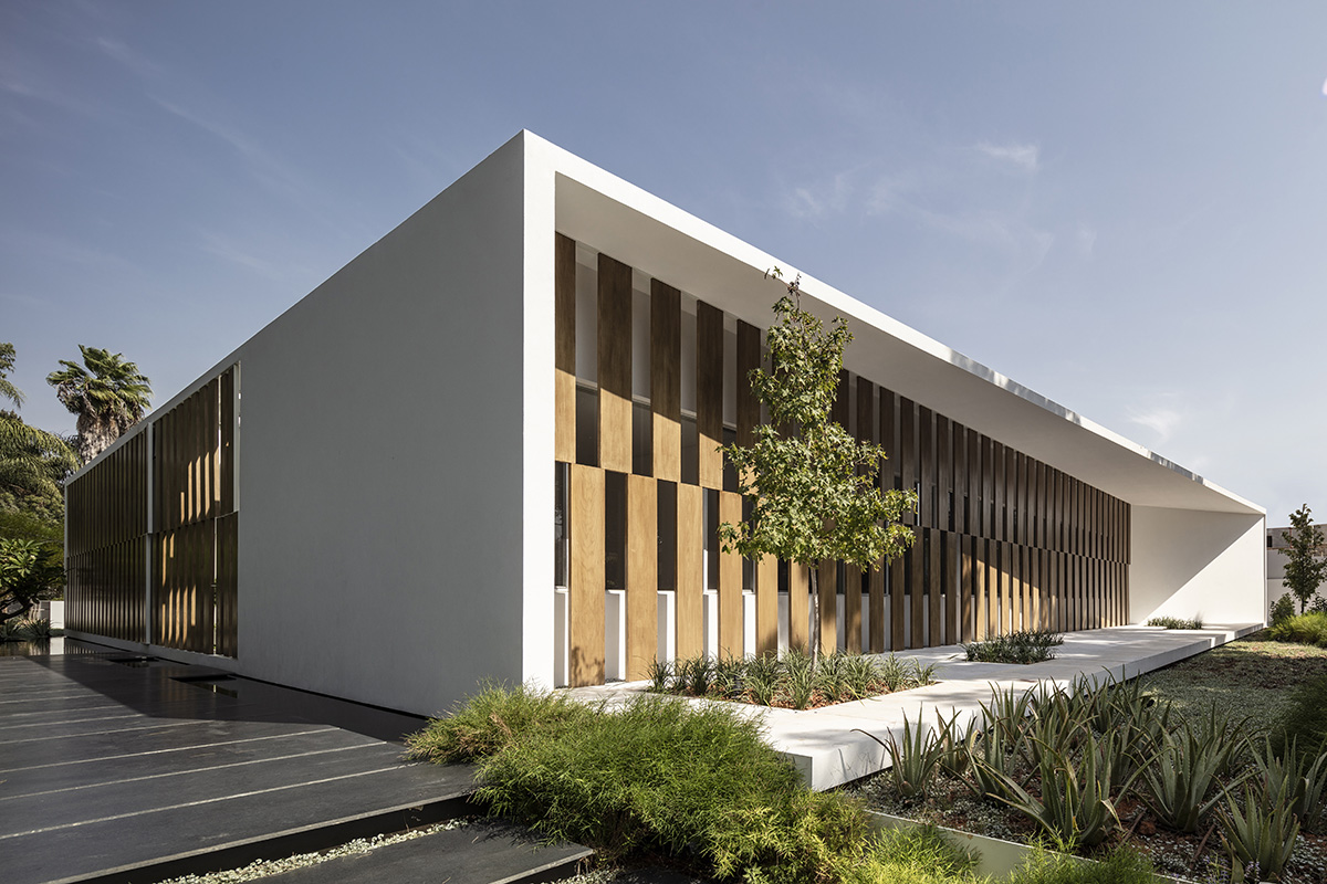 Large sunken yard defines the program of Split House designed by Pitsou Kedem Architects in Israel