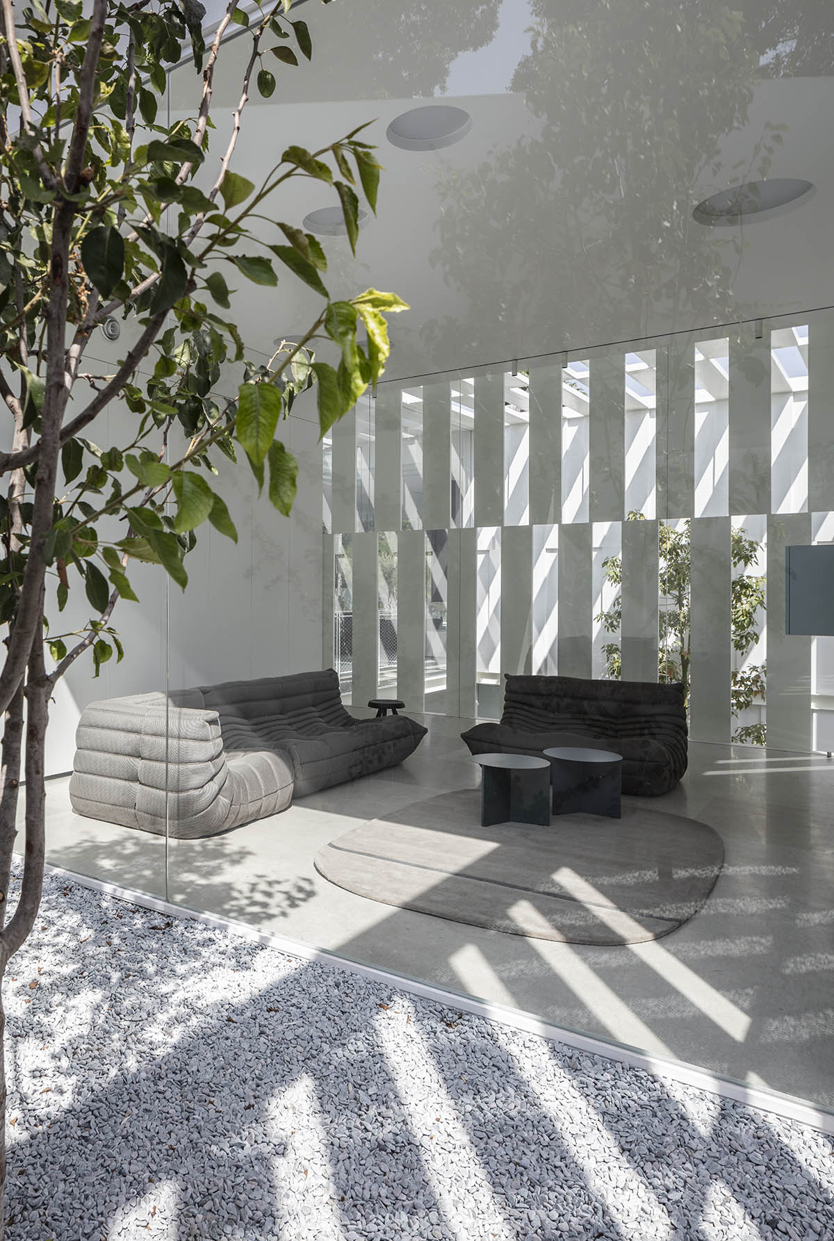 Large sunken yard defines the program of Split House designed by Pitsou Kedem Architects in Israel