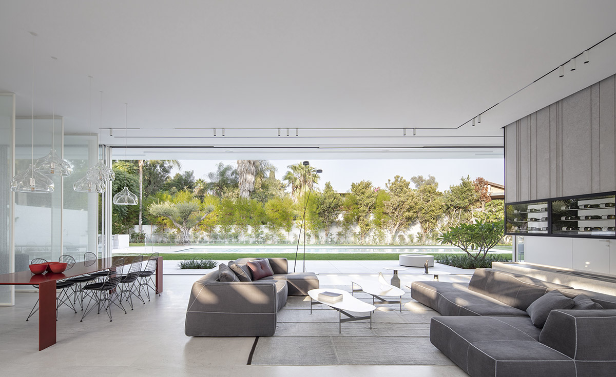 Large sunken yard defines the program of Split House designed by Pitsou Kedem Architects in Israel