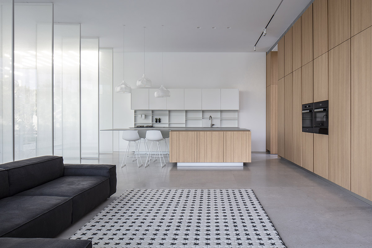 Large sunken yard defines the program of Split House designed by Pitsou Kedem Architects in Israel