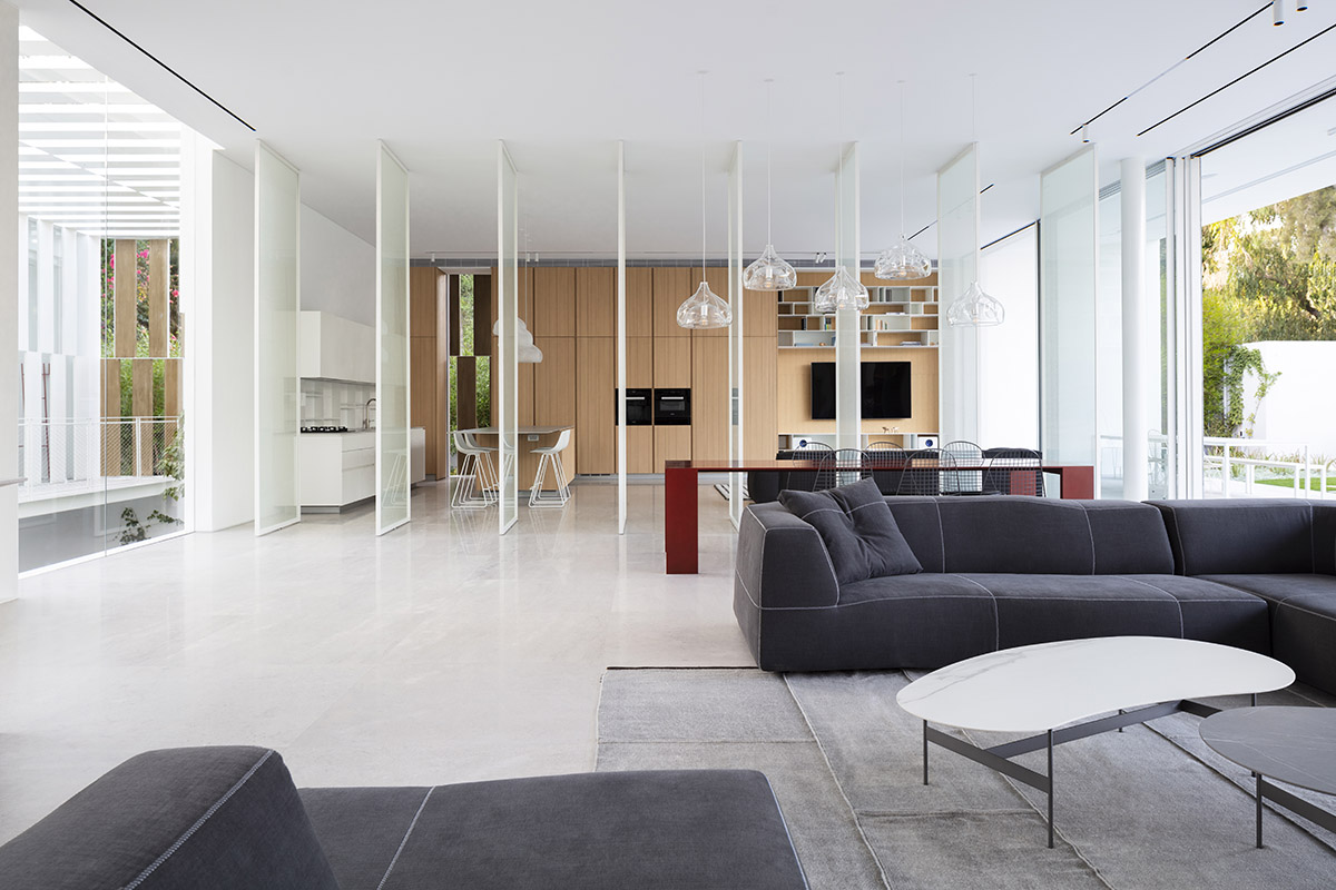 Large sunken yard defines the program of Split House designed by Pitsou Kedem Architects in Israel