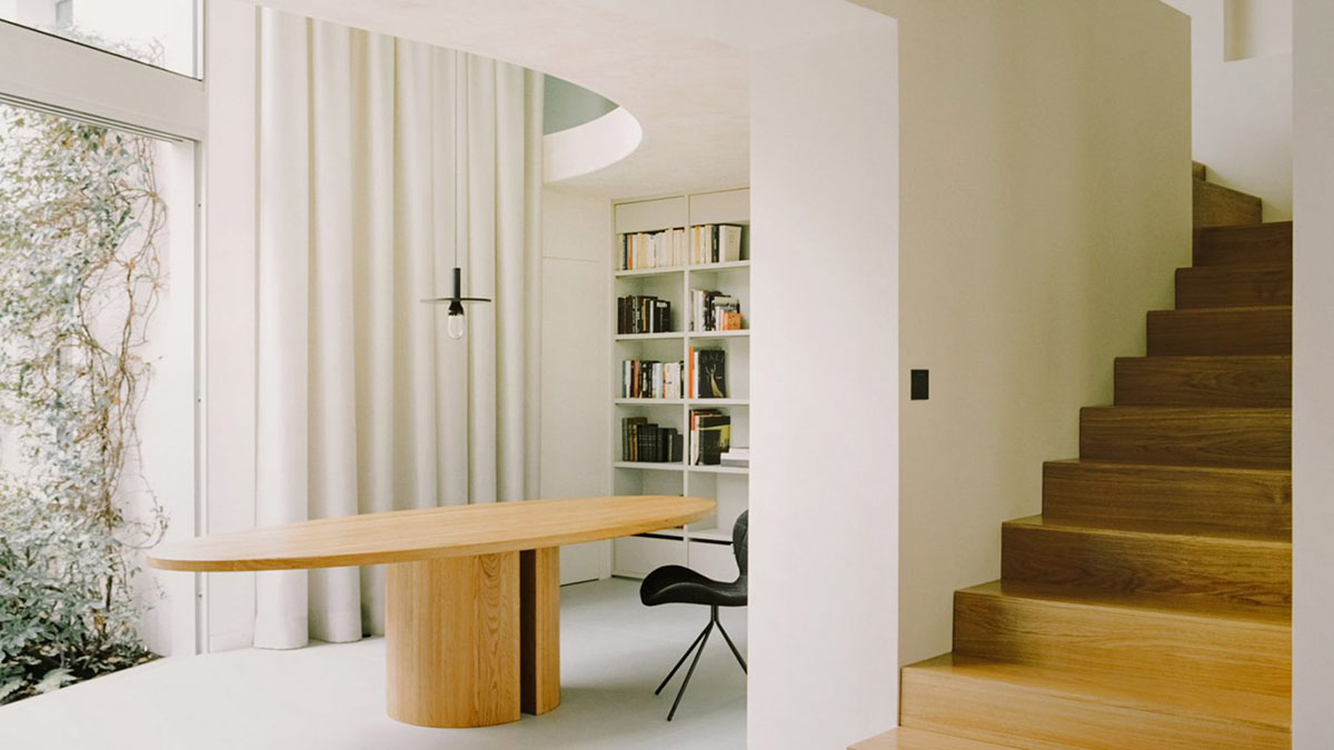 White concrete curved bridge gently complements interiors of The Island House in Paris