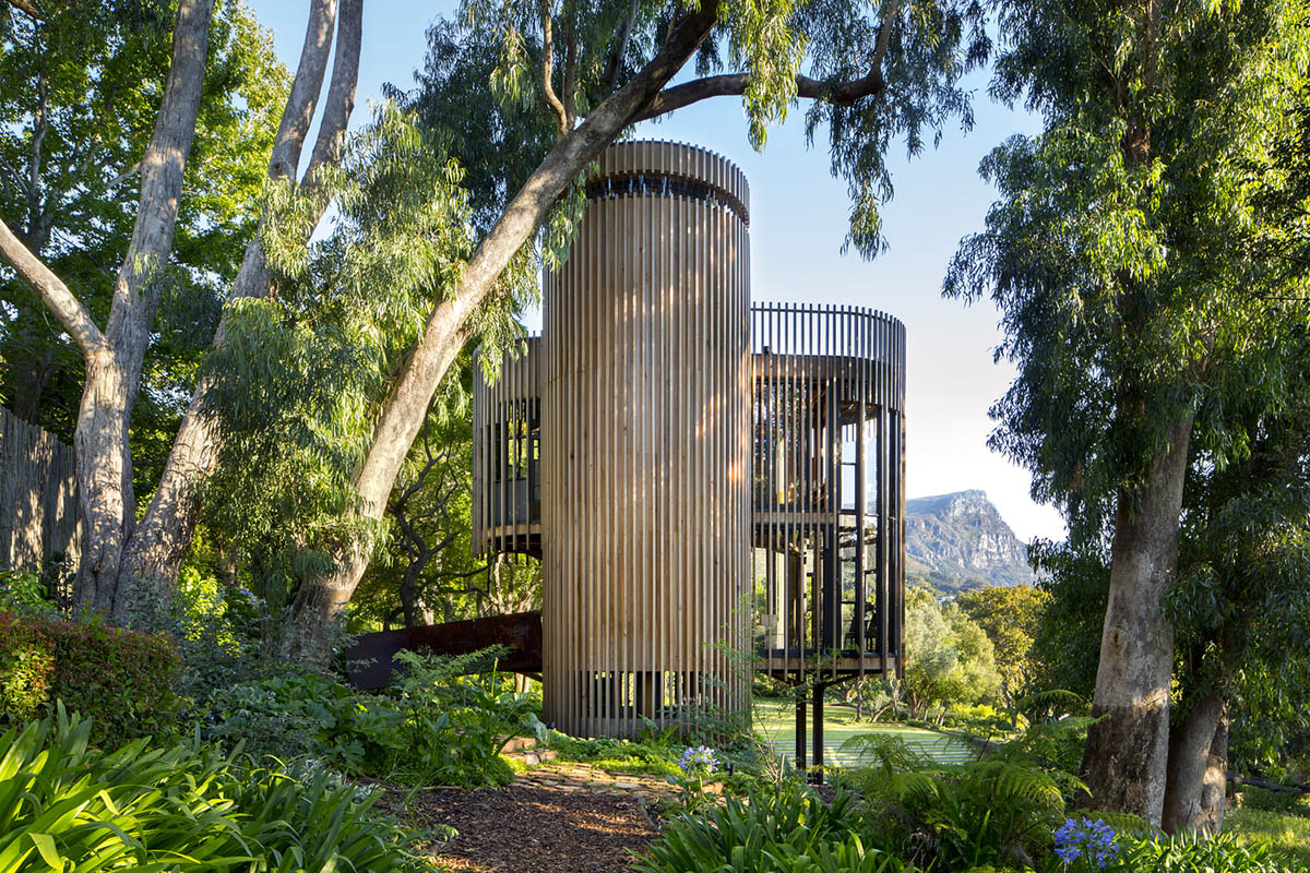 Circular tree house is raised over slender stilts to dominate the forest in every direction