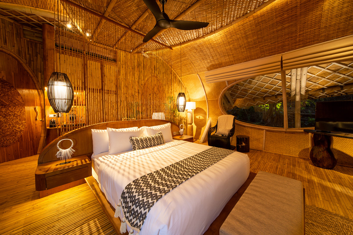 Undulating bamboo roofs wrap this wellness retreat in a lush forest of Bali