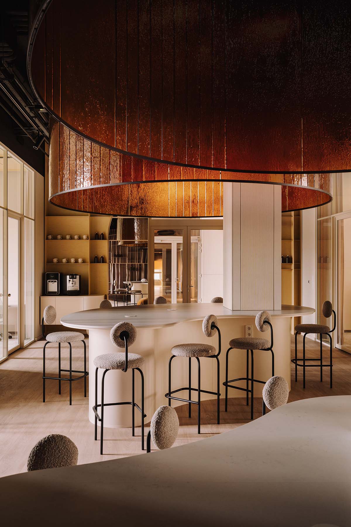 This copper-hued co-working space interior is designed to inspire creative work in Wrocław