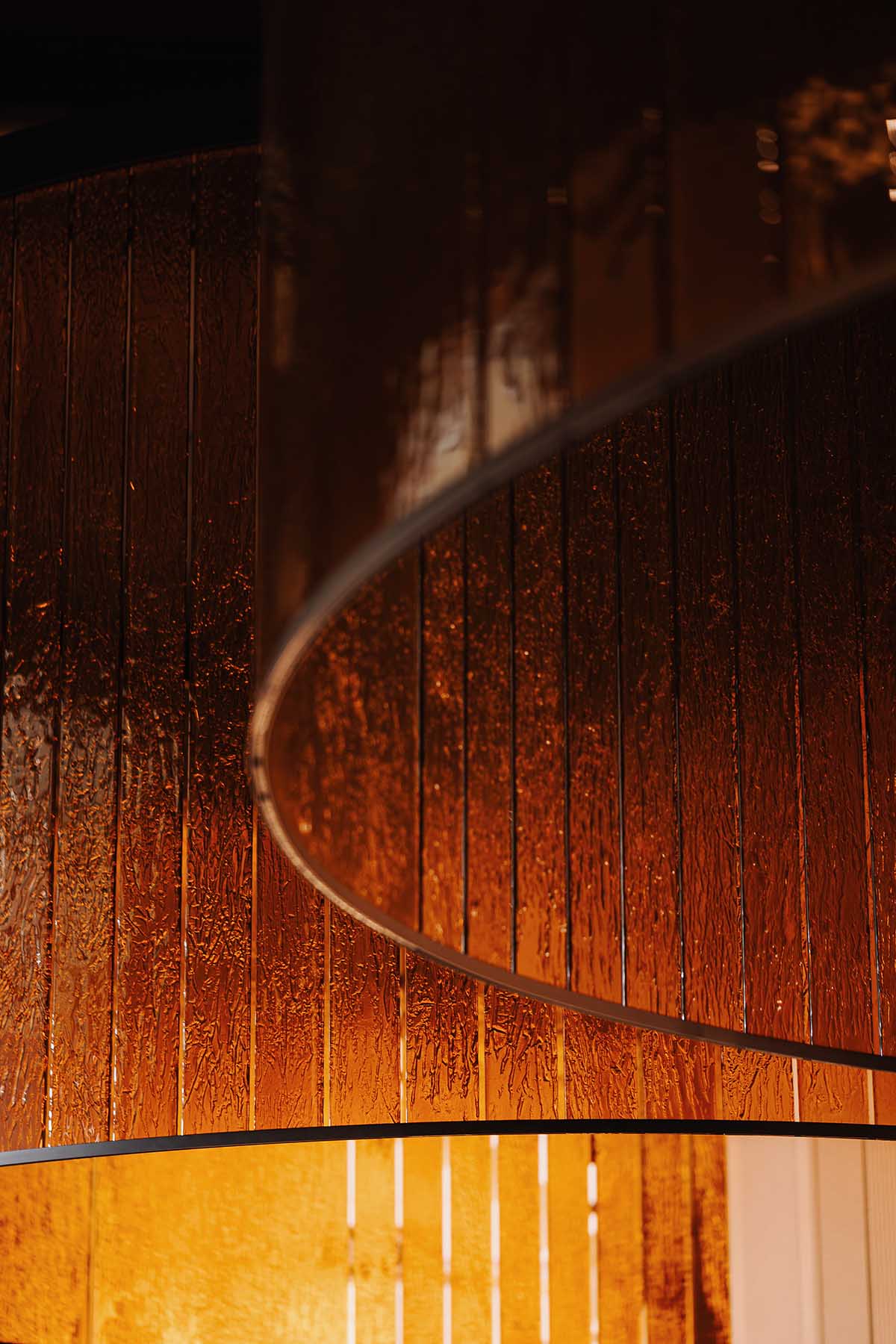 This copper-hued co-working space interior is designed to inspire creative work in Wrocław