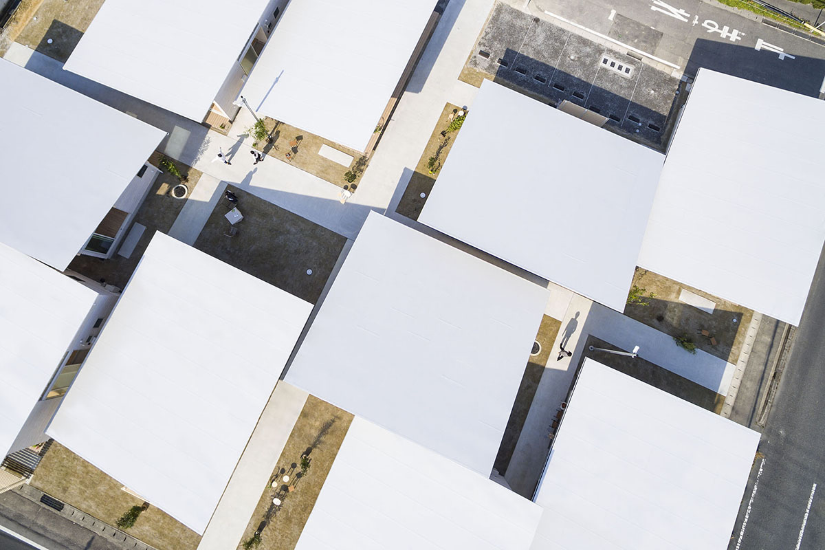 Studio Velocity transforms 1950s stacked housing complex into flat wooden apartments in Japan