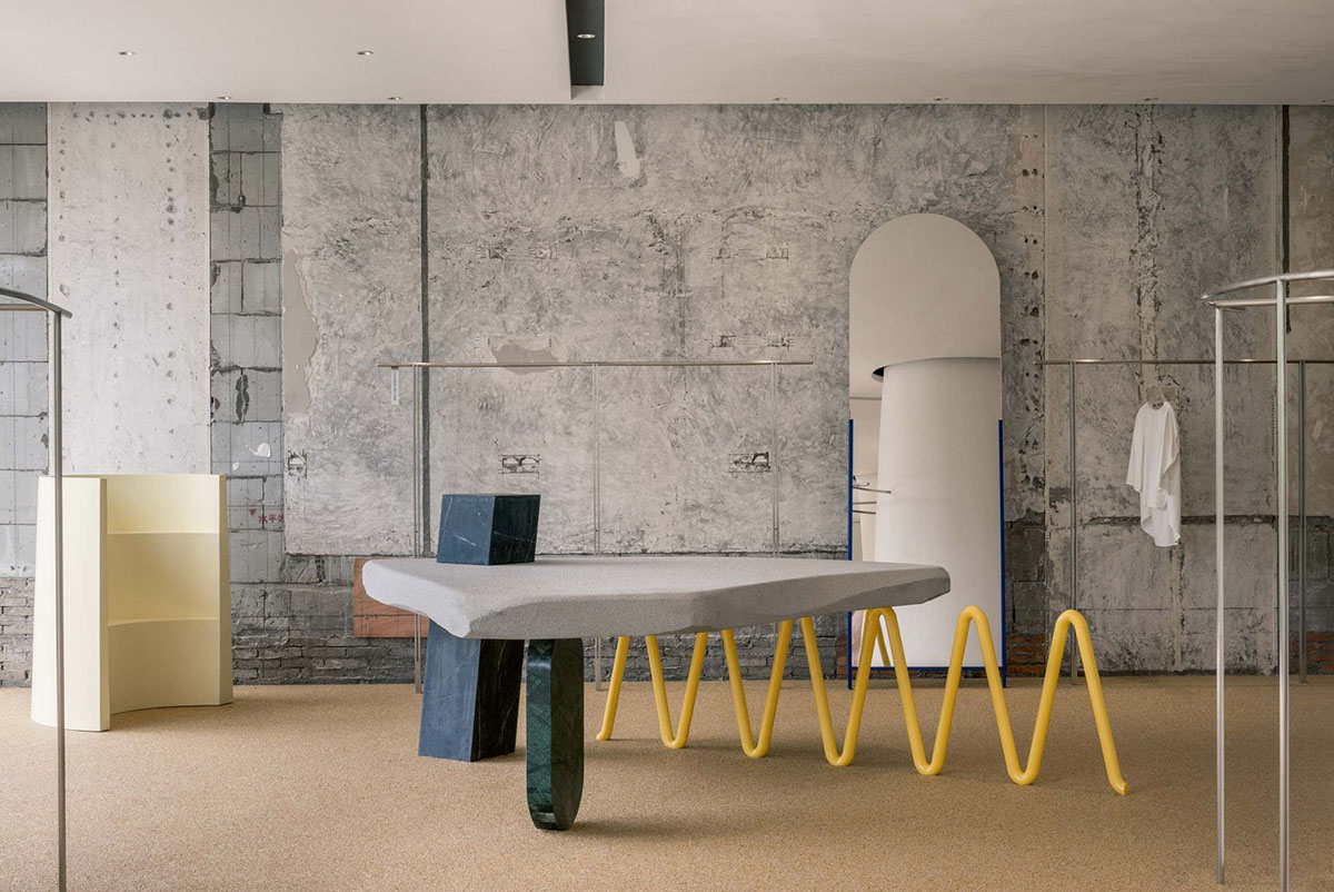 Cheese-like and stone tables with pinkish quirky-shaped elements add more personality to DSC store