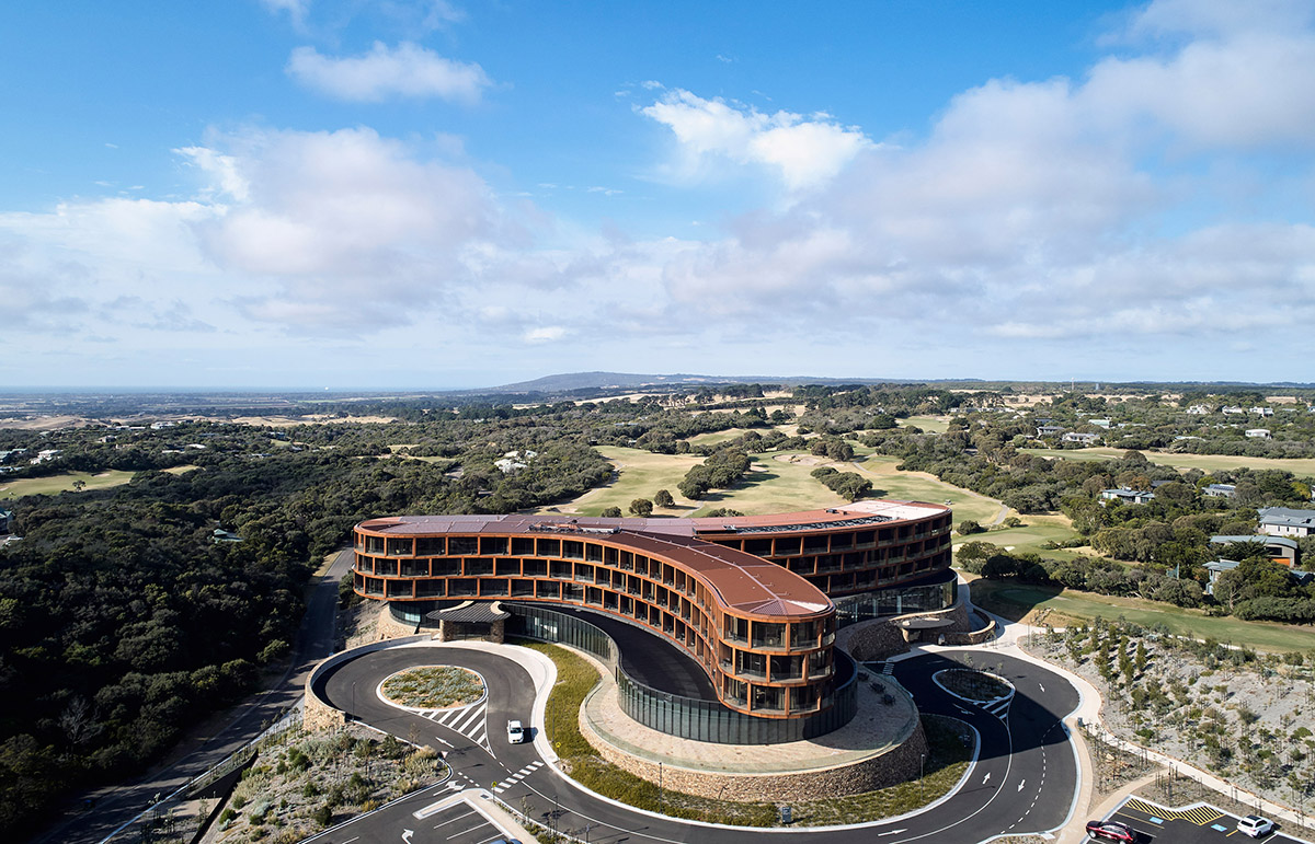 Wood Marsh completes sinuous resort anchored on hand-built locally sourced stone plinth in Australia