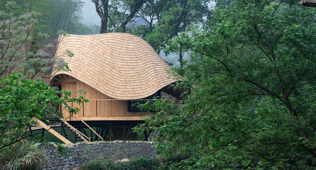 MONOARCHI built villa hotel with curvaceous roof in a lush green of Zhejiang