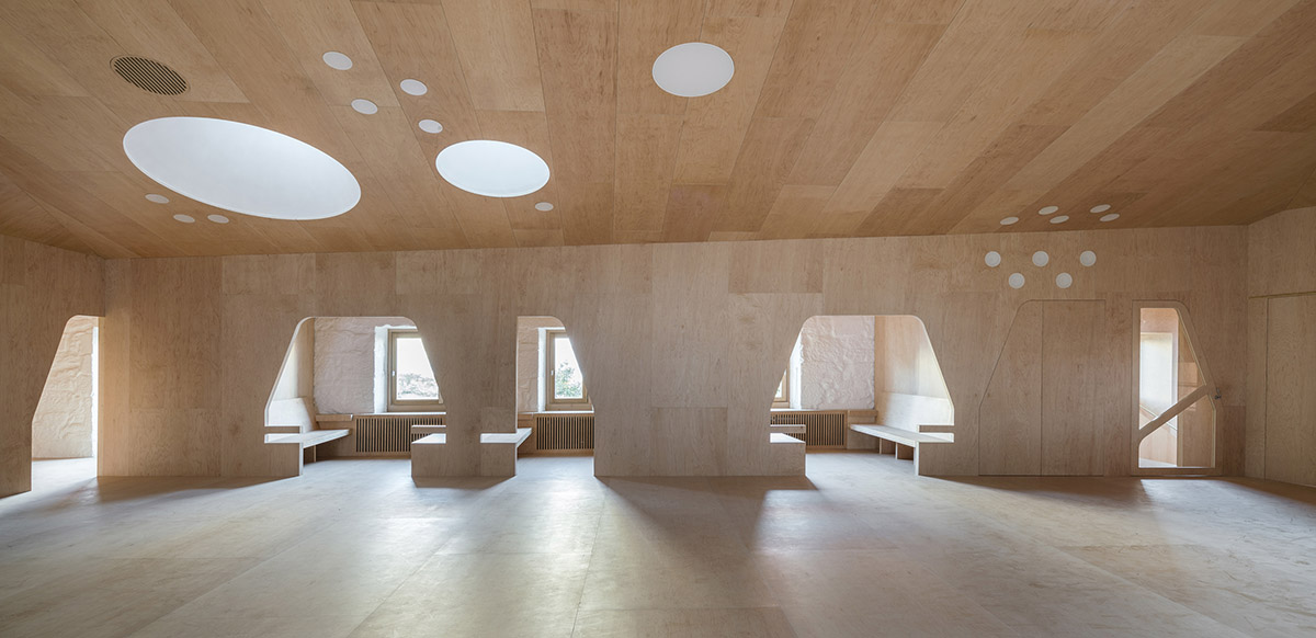 Murado & Elvira Architects transforms old hospital into a punched wooden library in Baiona