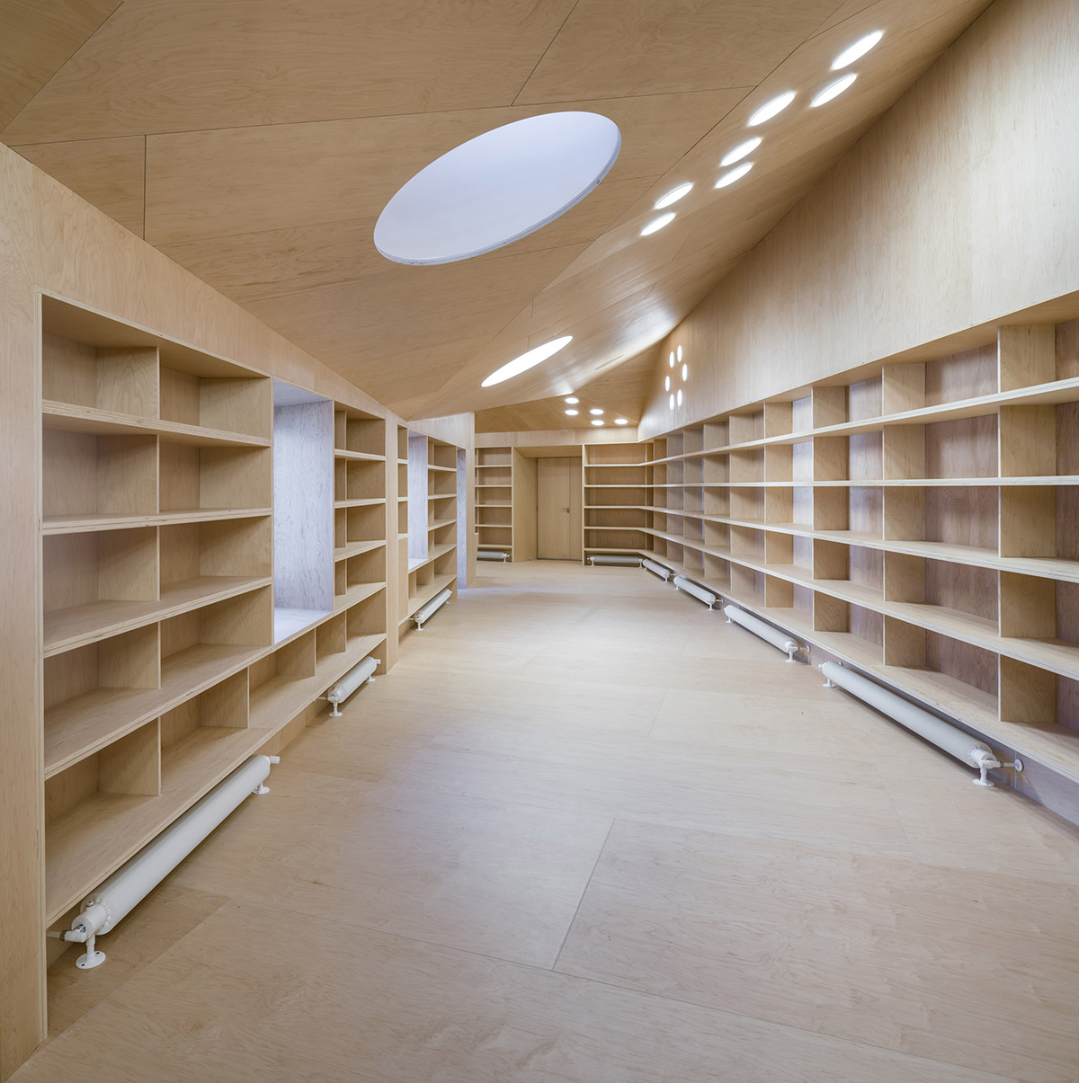Murado & Elvira Architects transforms old hospital into a punched wooden library in Baiona