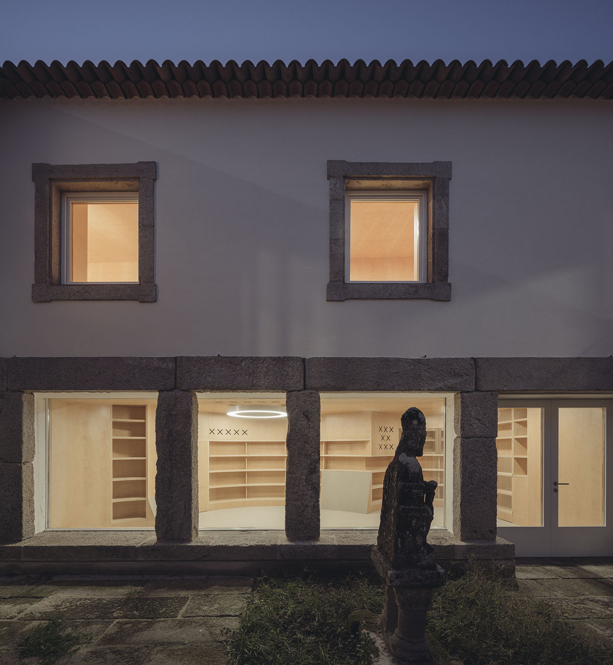 Murado & Elvira Architects transforms old hospital into a punched wooden library in Baiona