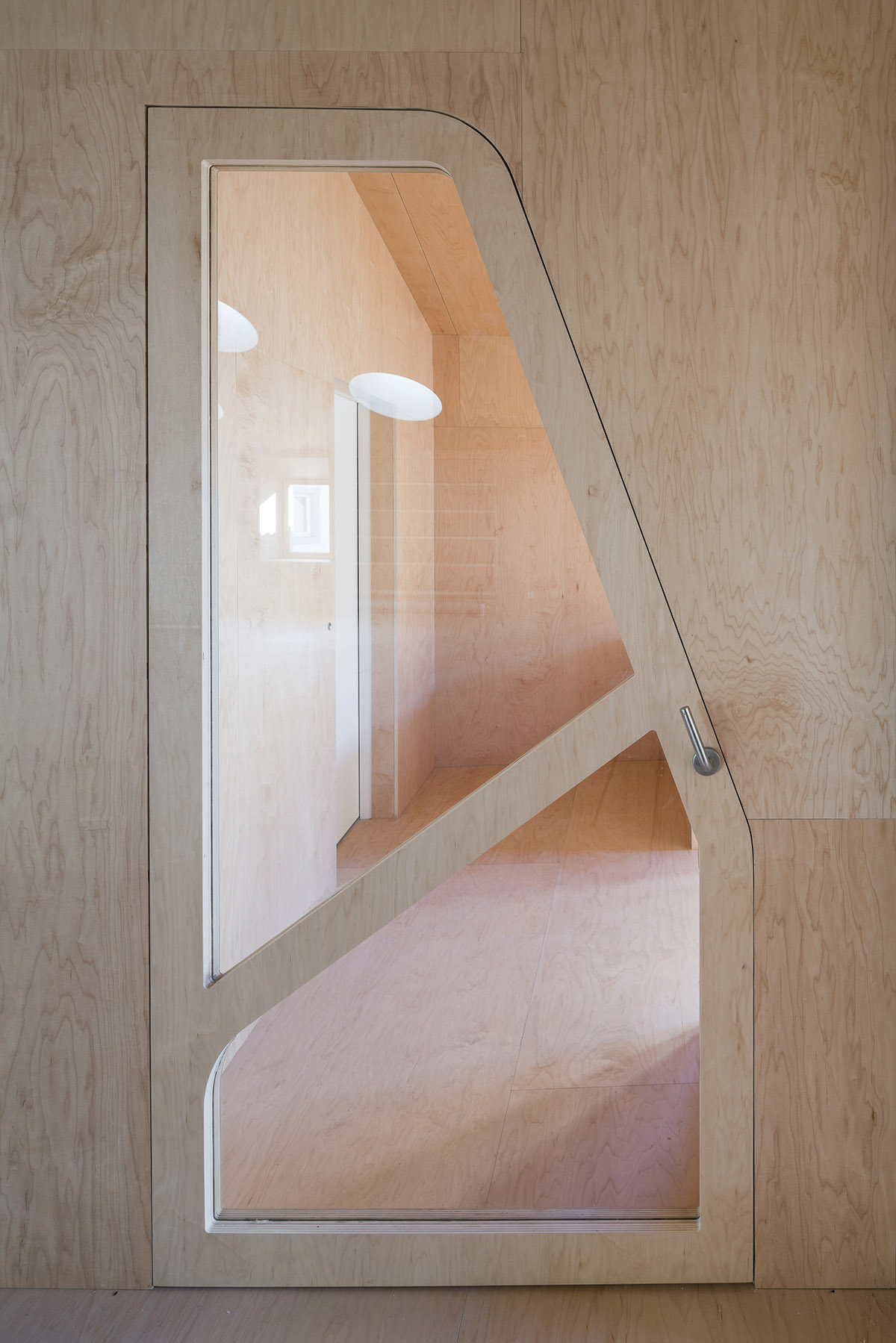 Murado & Elvira Architects transforms old hospital into a punched wooden library in Baiona