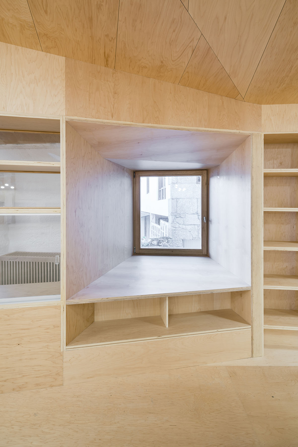 Murado & Elvira Architects transforms old hospital into a punched wooden library in Baiona