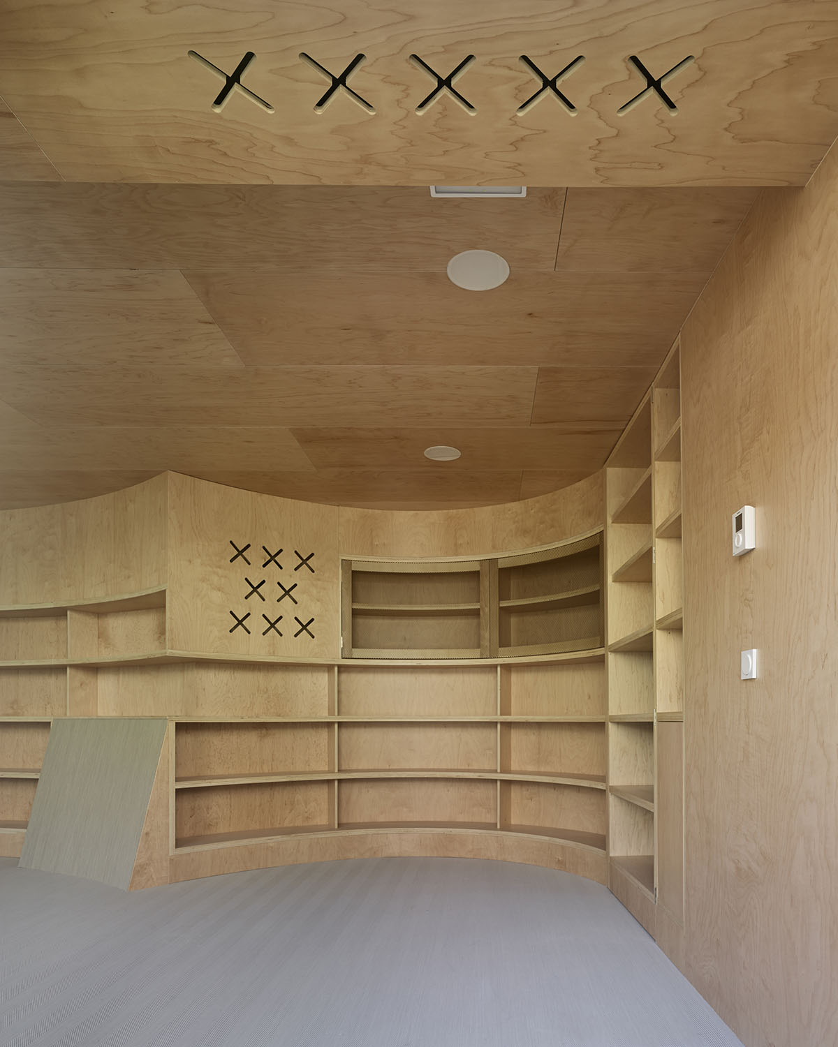 Murado & Elvira Architects transforms old hospital into a punched wooden library in Baiona