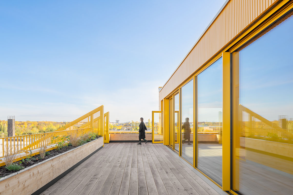 MVRDV revives old office building with bright yellow façade and zigzagging staircase in Berlin