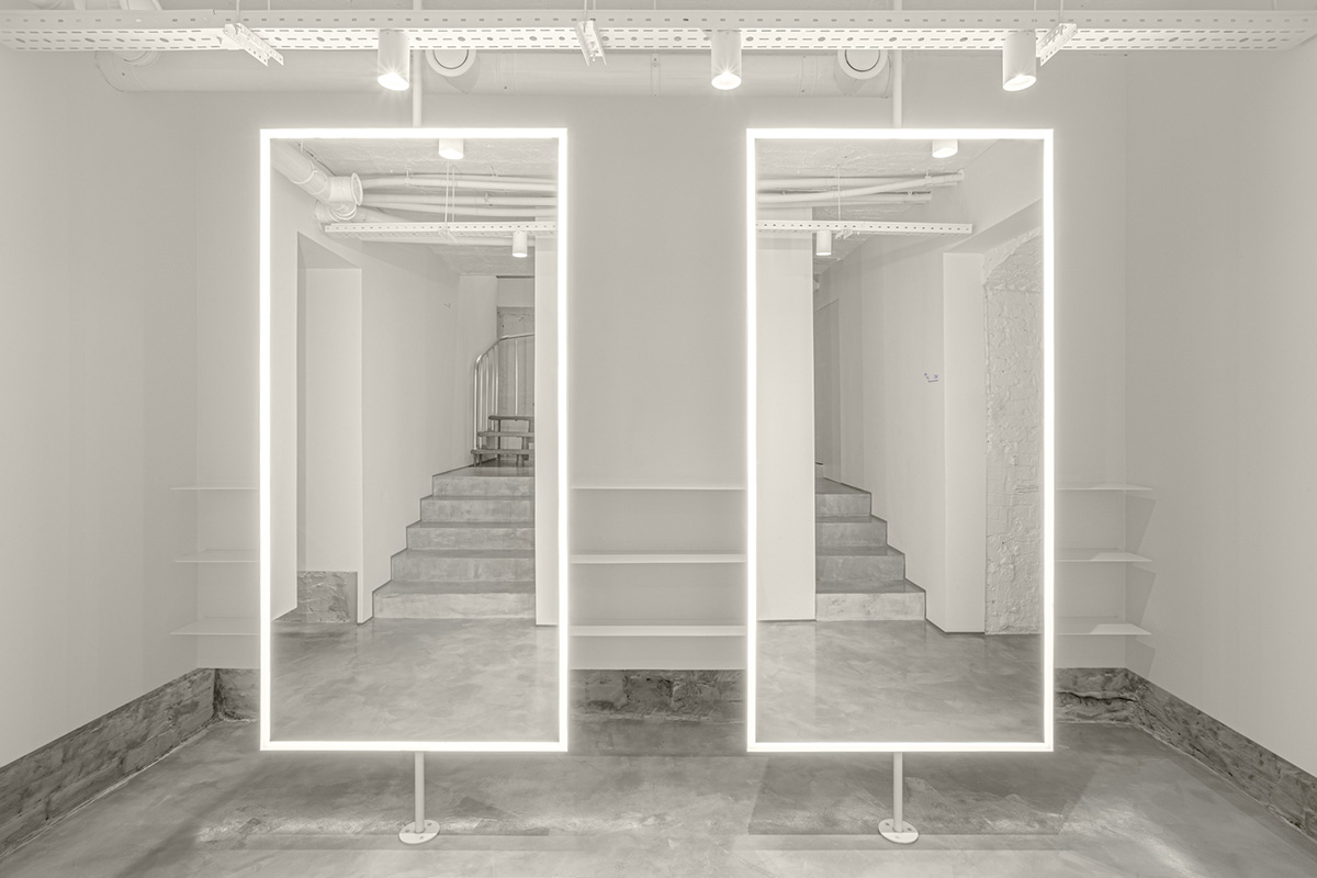 Cast-in-situ concrete, golden panels, metallic curtains soften beauty salon designed by balbek bureau