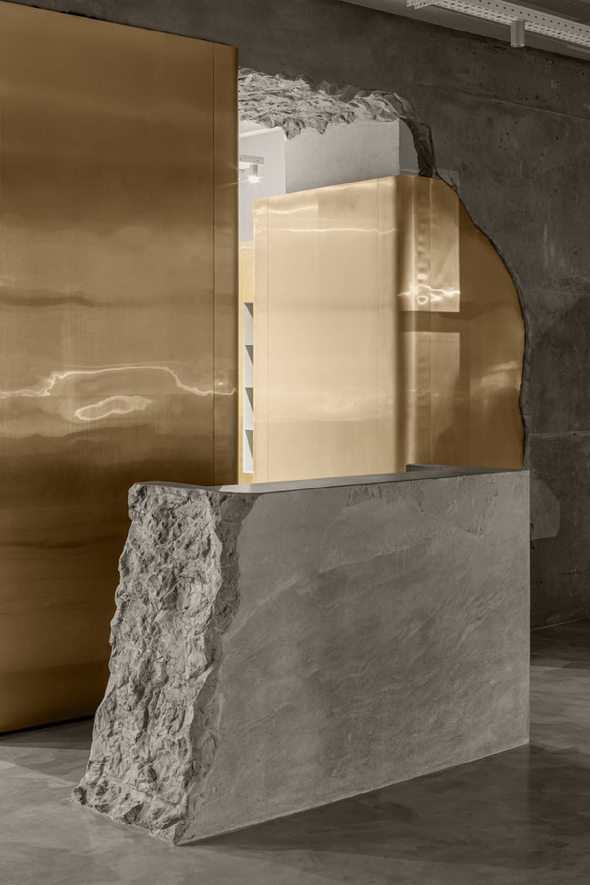 Cast-in-situ concrete, golden panels, metallic curtains soften beauty salon designed by balbek bureau