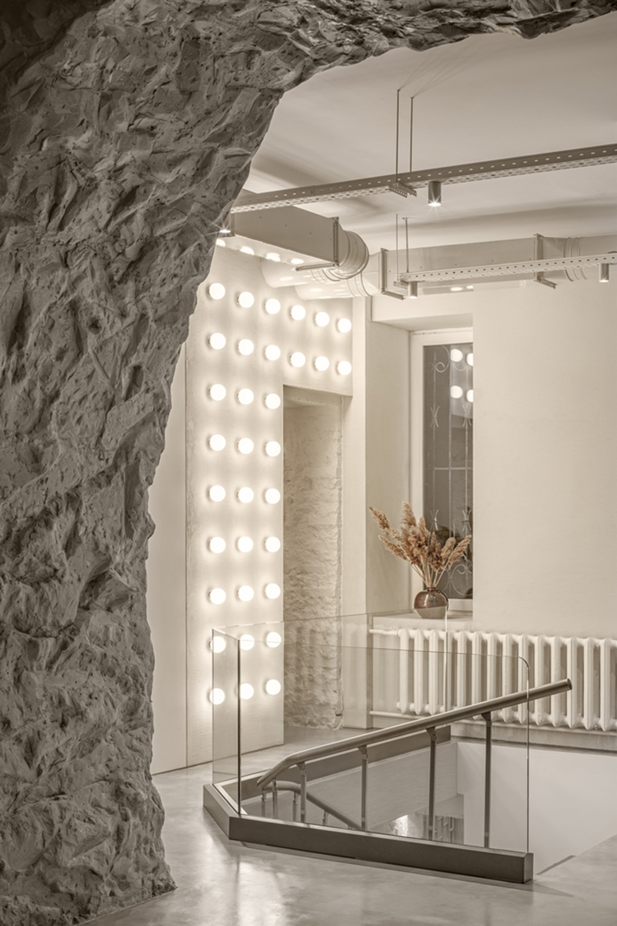 Cast-in-situ concrete, golden panels, metallic curtains soften beauty salon designed by balbek bureau