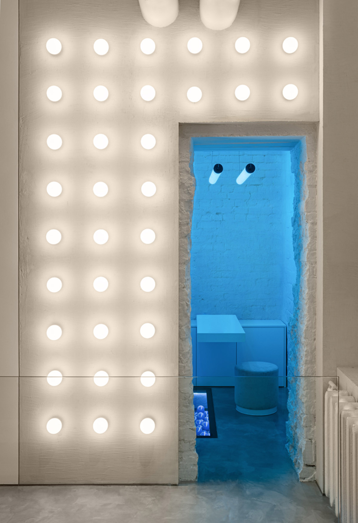 Cast-in-situ concrete, golden panels, metallic curtains soften beauty salon designed by balbek bureau