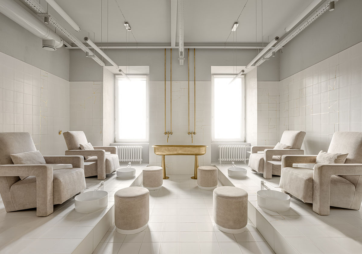 Cast-in-situ concrete, golden panels, metallic curtains soften beauty salon designed by balbek bureau