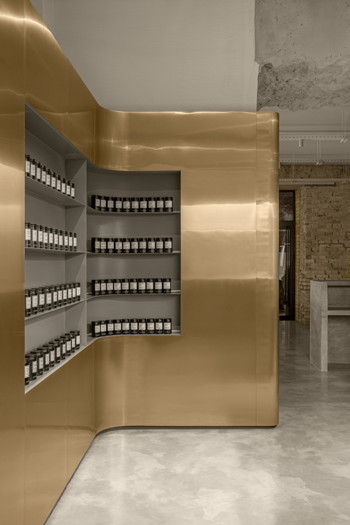 Cast-in-situ concrete, golden panels, metallic curtains soften beauty salon designed by balbek bureau