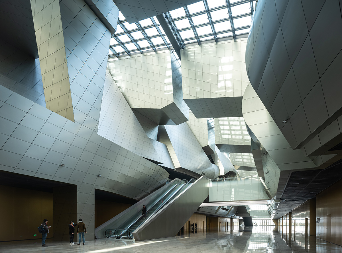 Morphosis designs conference center featuring undulating podium clad in titanium panels in China 