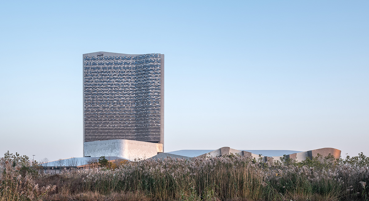 Morphosis designs conference center featuring undulating podium clad in titanium panels in China 