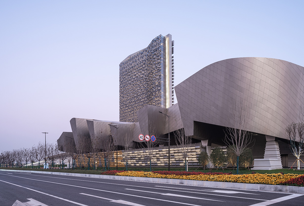 Morphosis designs conference center featuring undulating podium clad in titanium panels in China 