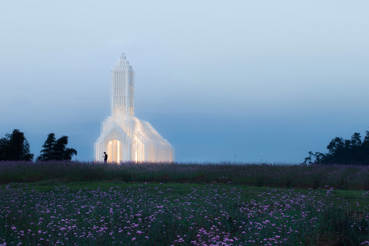 A church made of thousands of white thin beams looks like suspended in the air in lavender field